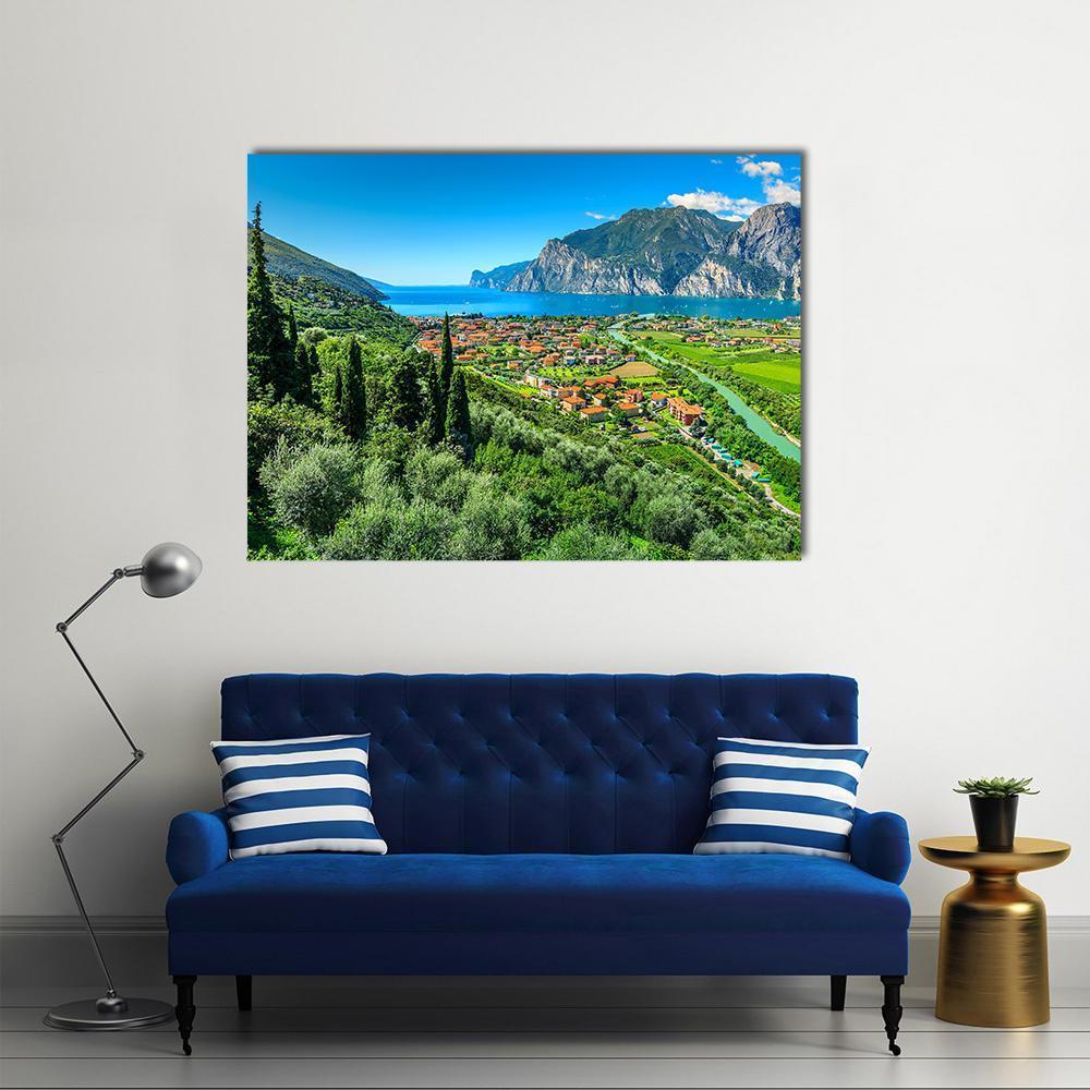 Lake Garda Village with Winding River Canvas Wall Art in green and blue, single panel hung on a wall