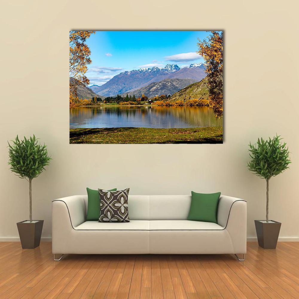 Lake Hayes in Autumn Canvas Wall Art in brown, yellow and blue, single panel hung on a wall
