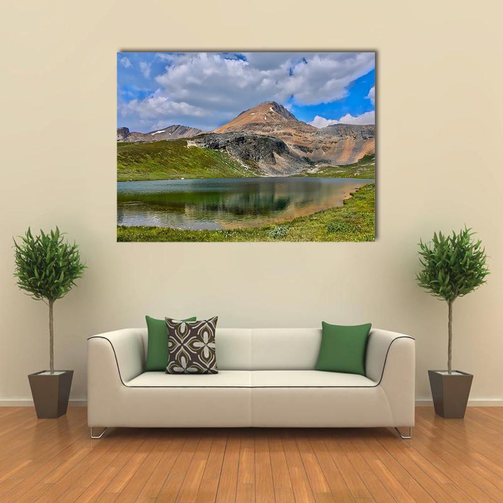 Alpine Lake with Mountain Reflection Canvas Wall Art in brown, green and blue, single panel hung on a wall