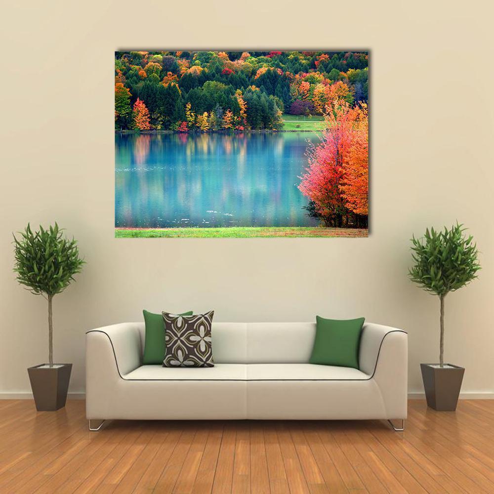 Autumn Lake Landscape Canvas Wall Art in orange, green and blue, single panel hung on a wall