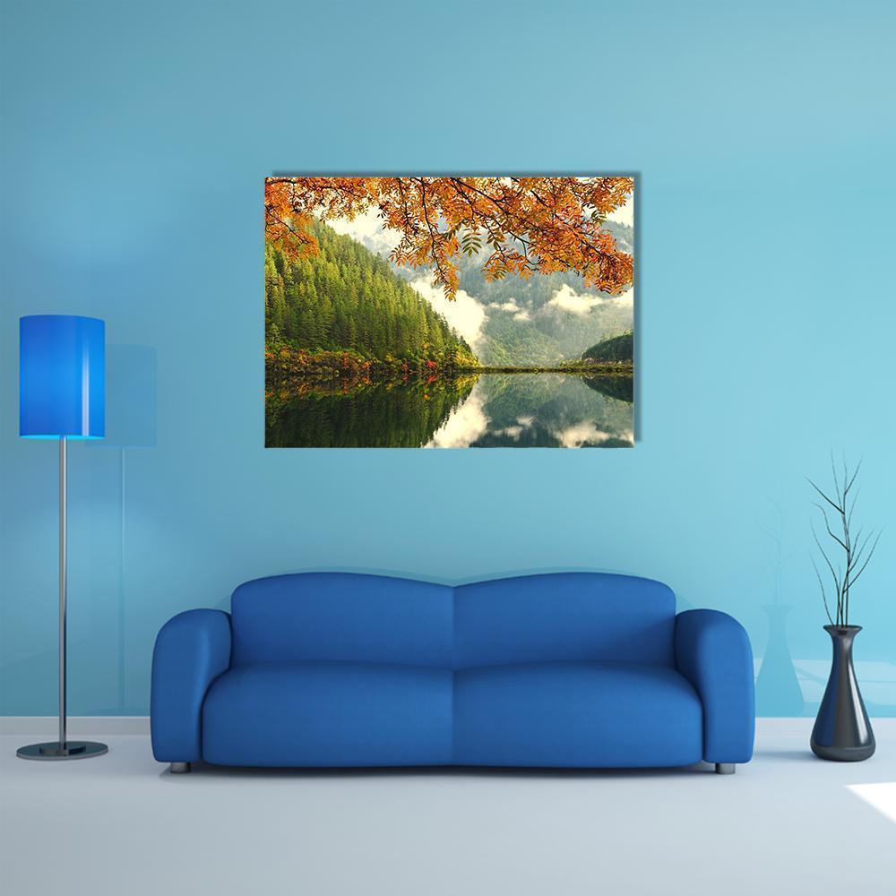 Autumn Mountain Lake Reflection Canvas Wall Art in orange, yellow and green, single panel hung on a wall