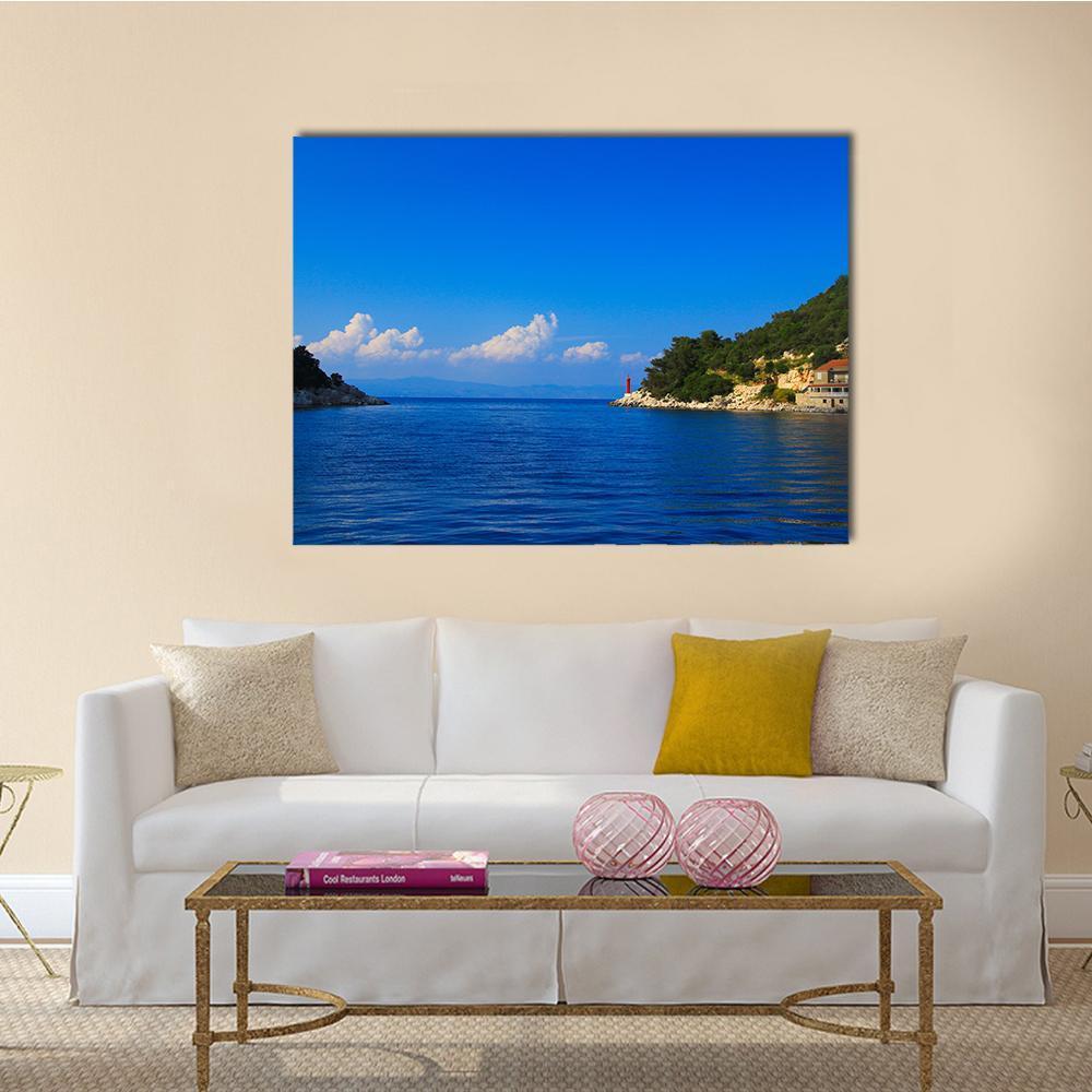 Croatian Lake with Red Lighthouse Canvas Wall Art in green and blue, single panel hung on a wall