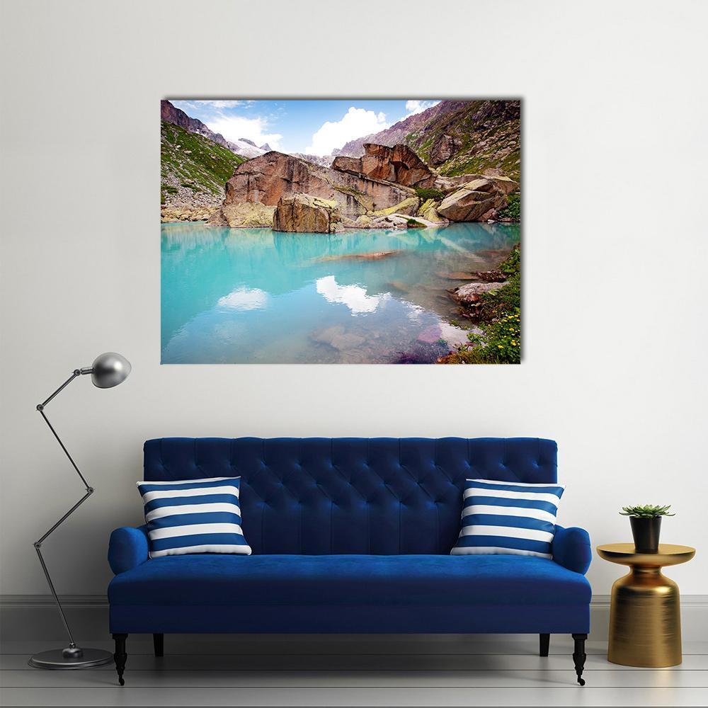 Turquoise Alpine Lake and Mountains Canvas Wall Art in brown, green and blue, single panel hung on a wall