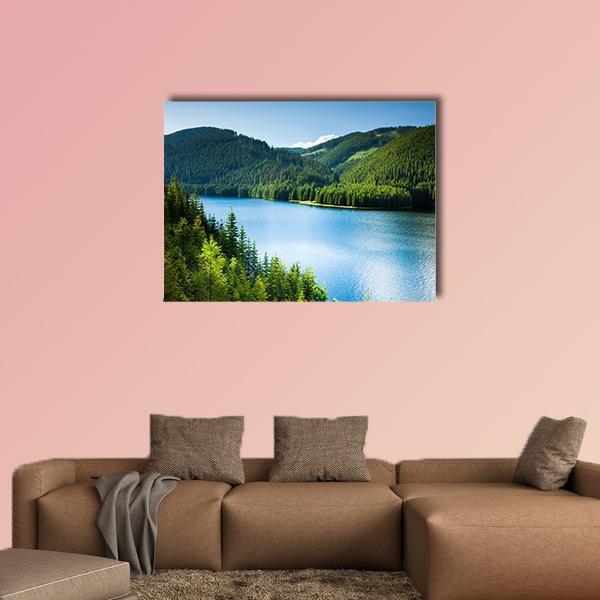 Lake in Pine Forest Canvas Wall Art in green and blue, single panel hung on a wall