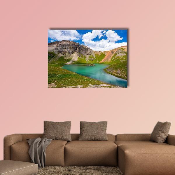 Turquoise Mountain Lake in Alpine Scenery Canvas Wall Art in brown, green and blue, single panel hung on a wall