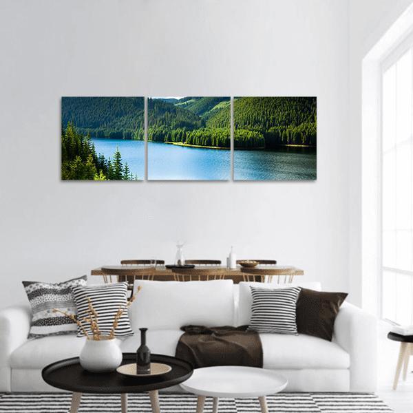 Lake in Pine Forest Panoramic Canvas Wall Art in green and blue, hung on a wall