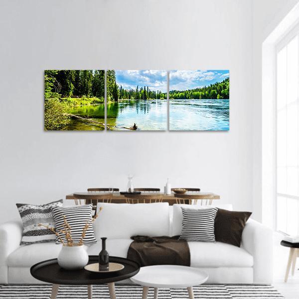 Clear Water Lake Landscape Panoramic Canvas Wall Art in white, green and blue, hung on a wall