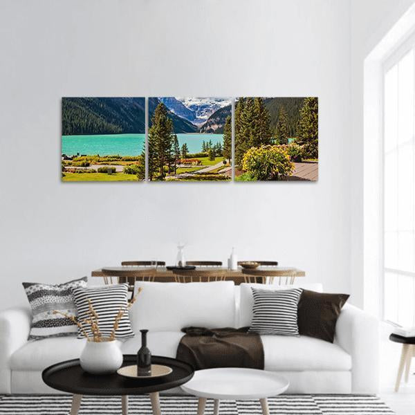 Turquoise Alpine Lake with Snow-capped Peaks Panoramic Canvas Wall Art in white, green and blue, hung on a wall