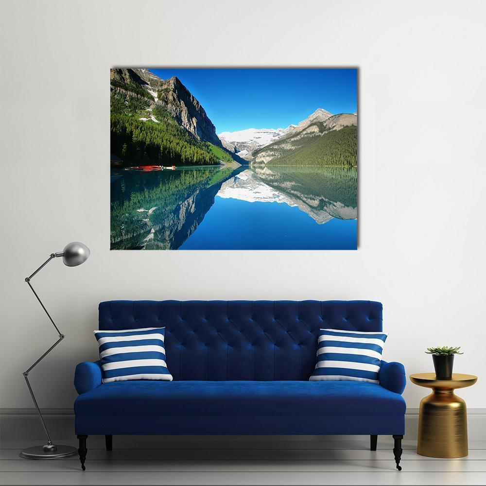 Mountain Lake Reflection with Red Boats Canvas Wall Art in green and blue, single panel hung on a wall