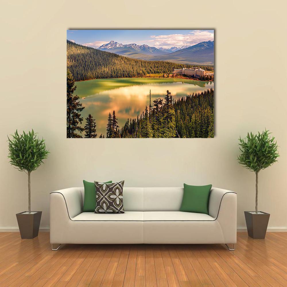 Alpine Lake Beneath Snow-capped Mountains Canvas Wall Art in brown, green and blue, single panel hung on a wall