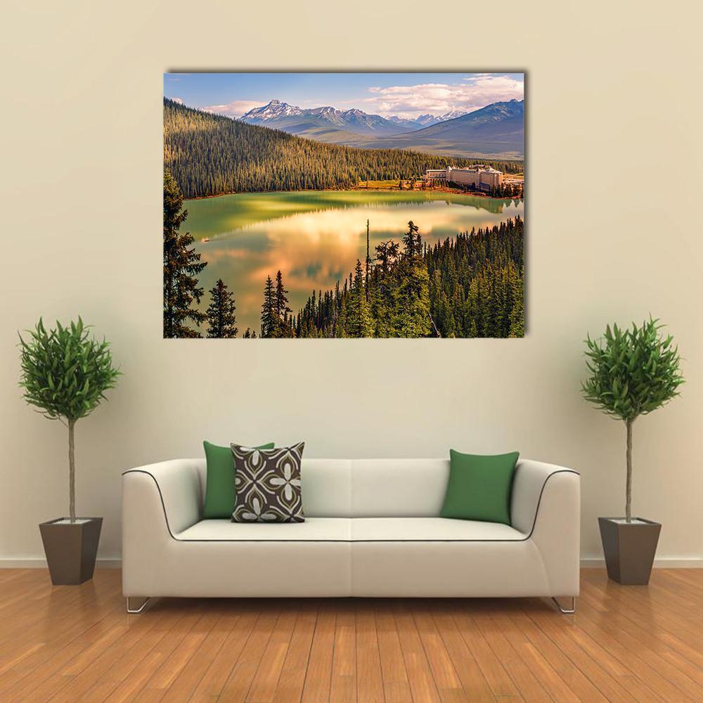 Lake Louise Beneath Snow-capped Mountains Canvas Wall Art in yellow, green and blue, single panel hung on a wall