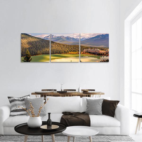 Lake Louise with Historic Shoreline Hotel Panoramic Canvas Wall Art in brown, green and blue, hung on a wall