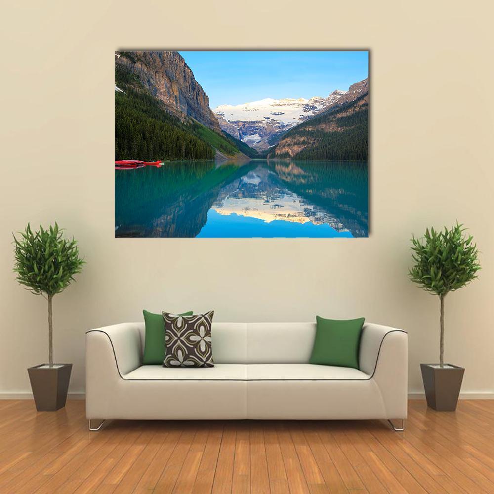 Lake Louise with Red Canoe Canvas Wall Art in white, green and blue, single panel hung on a wall