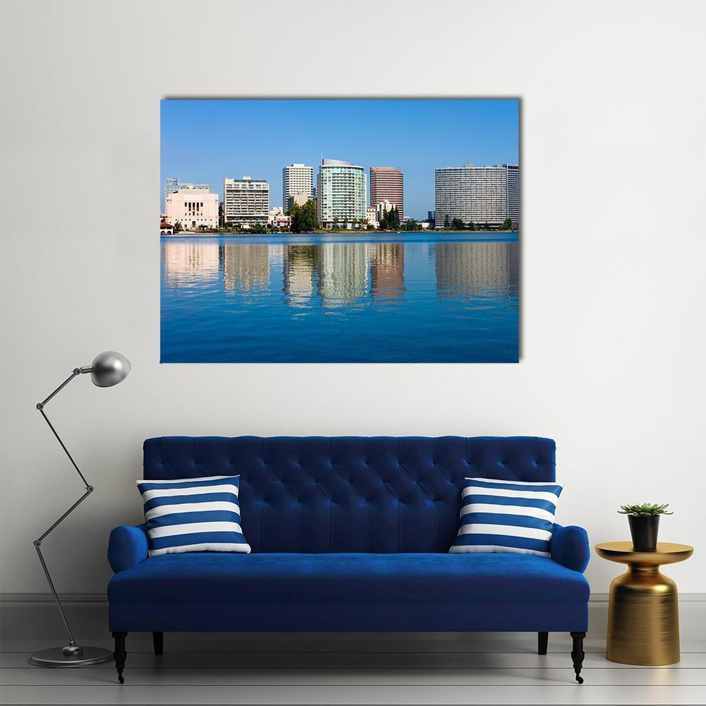 Lake Merritt Waterfront Reflection Canvas Wall Art in white, gray and blue, single panel hung on a wall