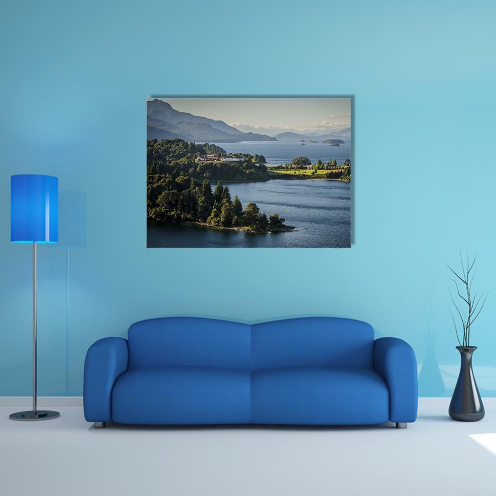 Mountain Lake with Wooded Peninsula Canvas Wall Art in gray, green and blue, single panel hung on a wall
