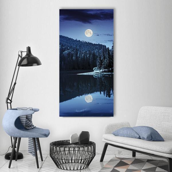 Moonlit Lake by Pine Forest Vertical Canvas Wall Art in white, blue and navy, single vertical panel hung on a wall