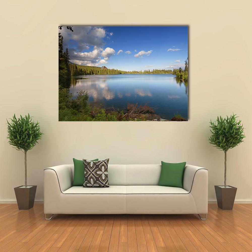 Mountain Lake with Reflections Canvas Wall Art in white, green and blue, single panel hung on a wall