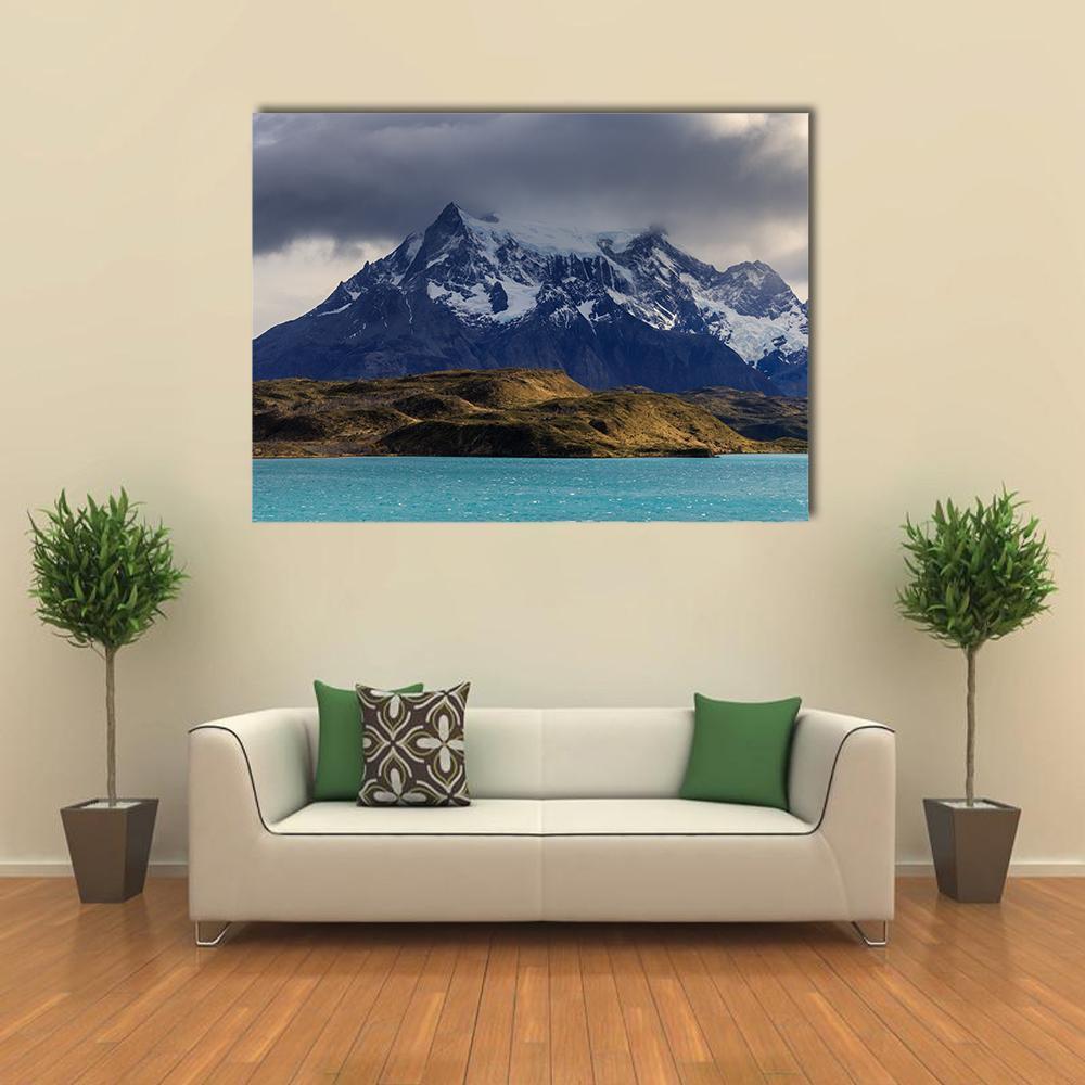 Lake Pehoe Turquoise Water and Snow-capped Mountains Canvas Wall Art in gray, brown and blue, single panel hung on a wall