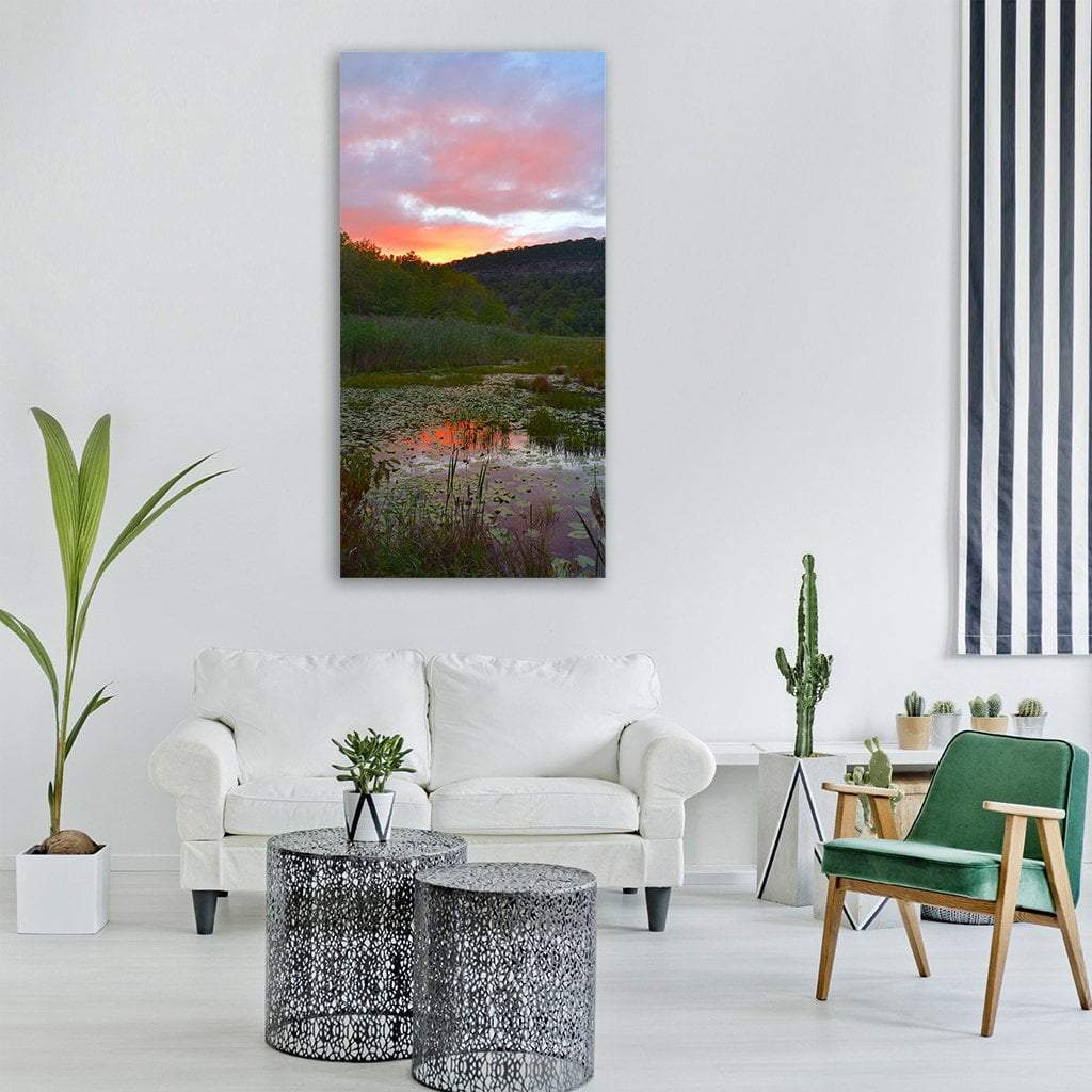 Marshland Pond at Sunset Vertical Canvas Wall Art in orange, green and pink, single vertical panel hung on a wall
