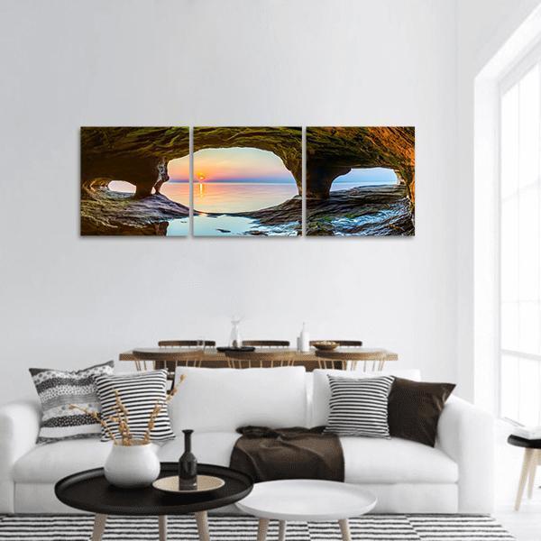 Lake Superior Sea Cave Sunset Panoramic Canvas Wall Art in brown, orange and blue, hung on a wall