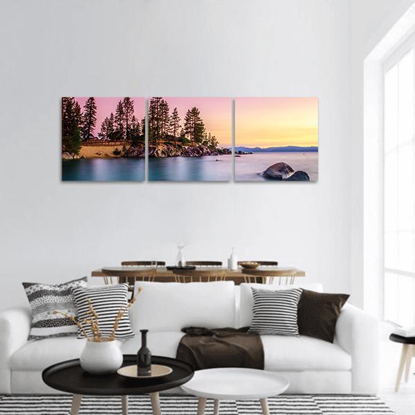 Sunrise Over Lake Tahoe Panoramic Canvas Wall Art in orange, blue and pink, hung on a wall