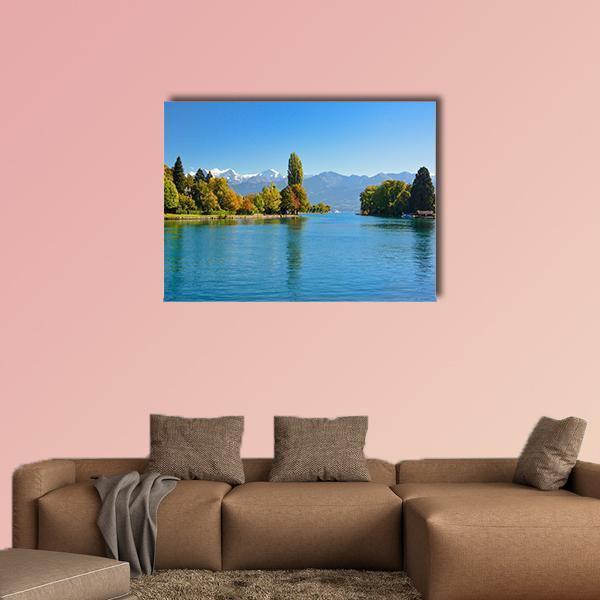 Lake Thun in Autumn Canvas Wall Art in green and blue, single panel hung on a wall