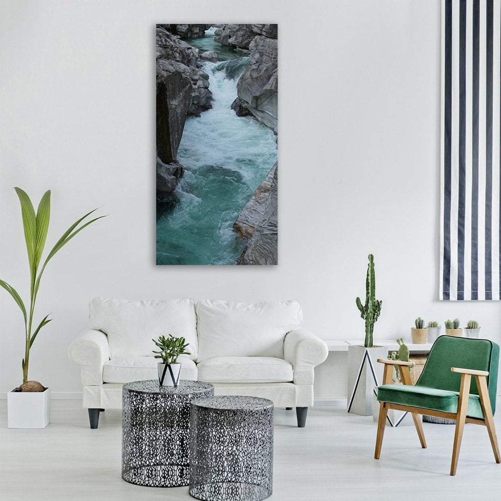 Turquoise Rapids in a Narrow Gorge Vertical Canvas Wall Art in white, gray and blue, single vertical panel hung on a wall