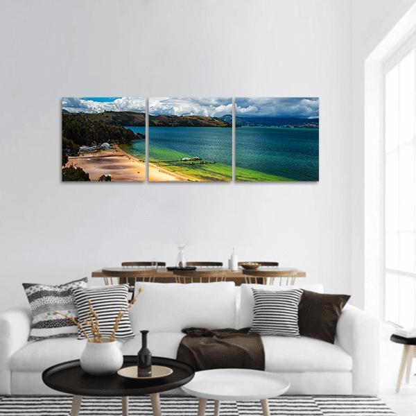 Lake Tota Turquoise Bay and Lush Hills Panoramic Canvas Wall Art in green and blue, hung on a wall