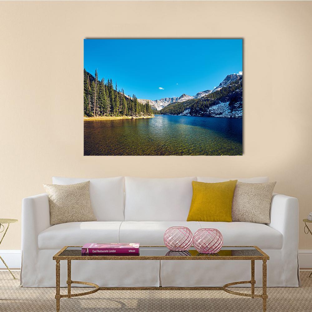 Sunlit Mountain Lake with Evergreens Canvas Wall Art in brown, green and blue, single panel hung on a wall
