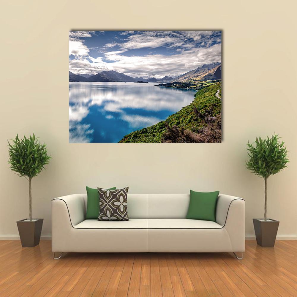 Lake Wakatipu Reflection Canvas Wall Art in white, green and blue, single panel hung on a wall