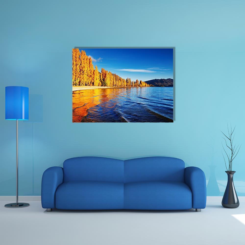 Lake Wanaka Golden Autumn Reflection Canvas Wall Art in orange, yellow and blue, single panel hung on a wall