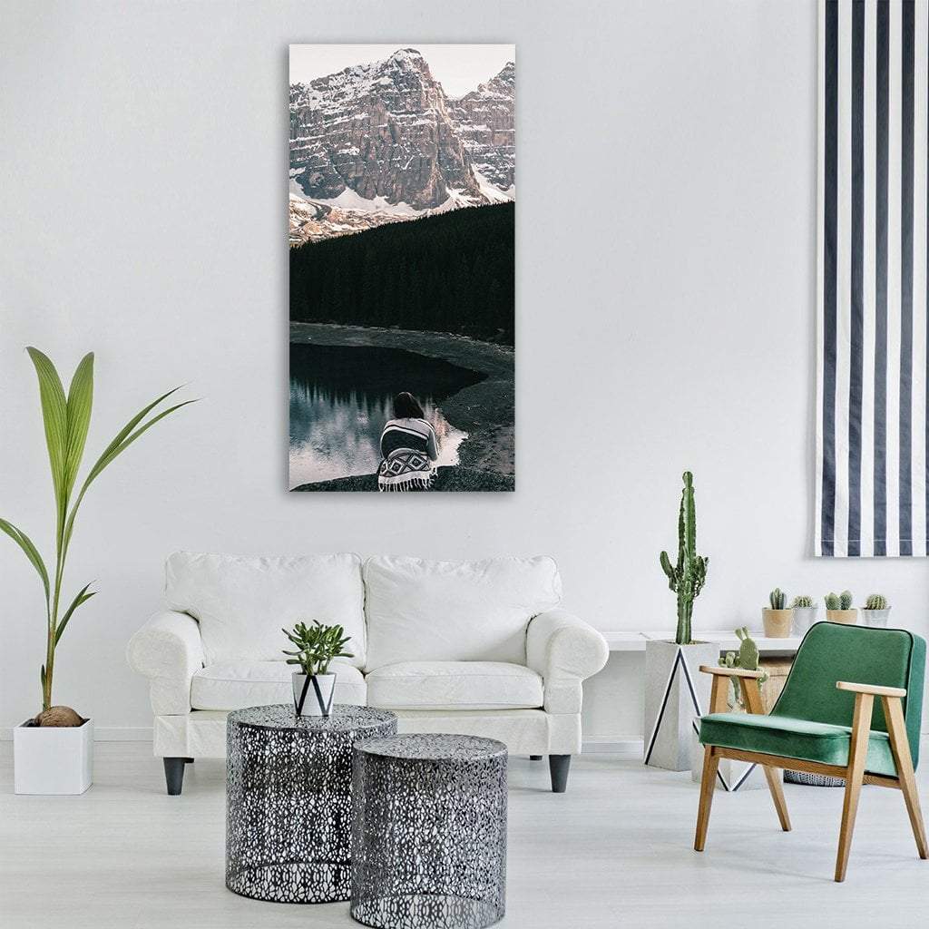 Person by Snow-capped Mountain Lake Vertical Canvas Wall Art in black, white and gray, single vertical panel hung on a wall