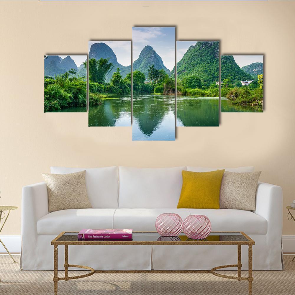 Karst Mountains with Lake Reflection Canvas Wall Art in green and blue, 5 panel Star layout hung on a wall