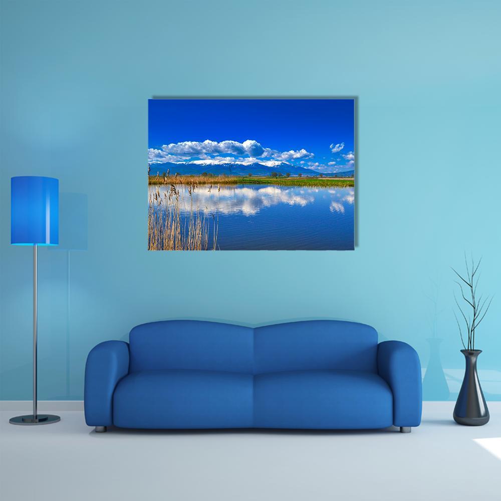 Snow-capped Mountain Lake with Reflections Canvas Wall Art in white and blue, single panel hung on a wall