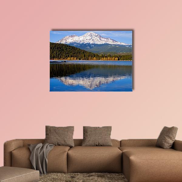 Snow-capped Mountain Over Clear Lake Canvas Wall Art in white, green and blue, single panel hung on a wall