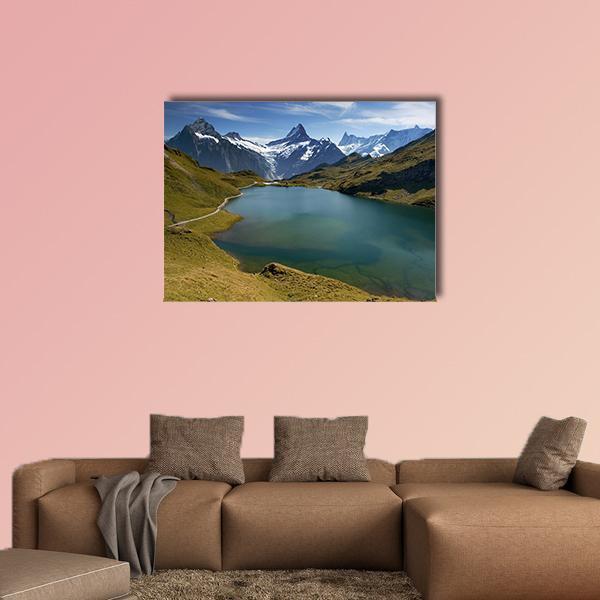 Alpine Lake with Snow-capped Peak Canvas Wall Art in white, green and blue, single panel hung on a wall