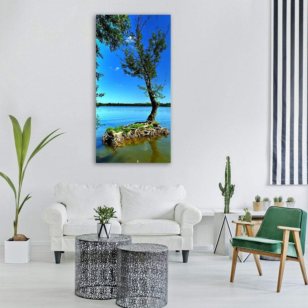 Lone Tree on Islet with Exposed Roots Vertical Canvas Wall Art in brown, green and blue, single vertical panel hung on a wall