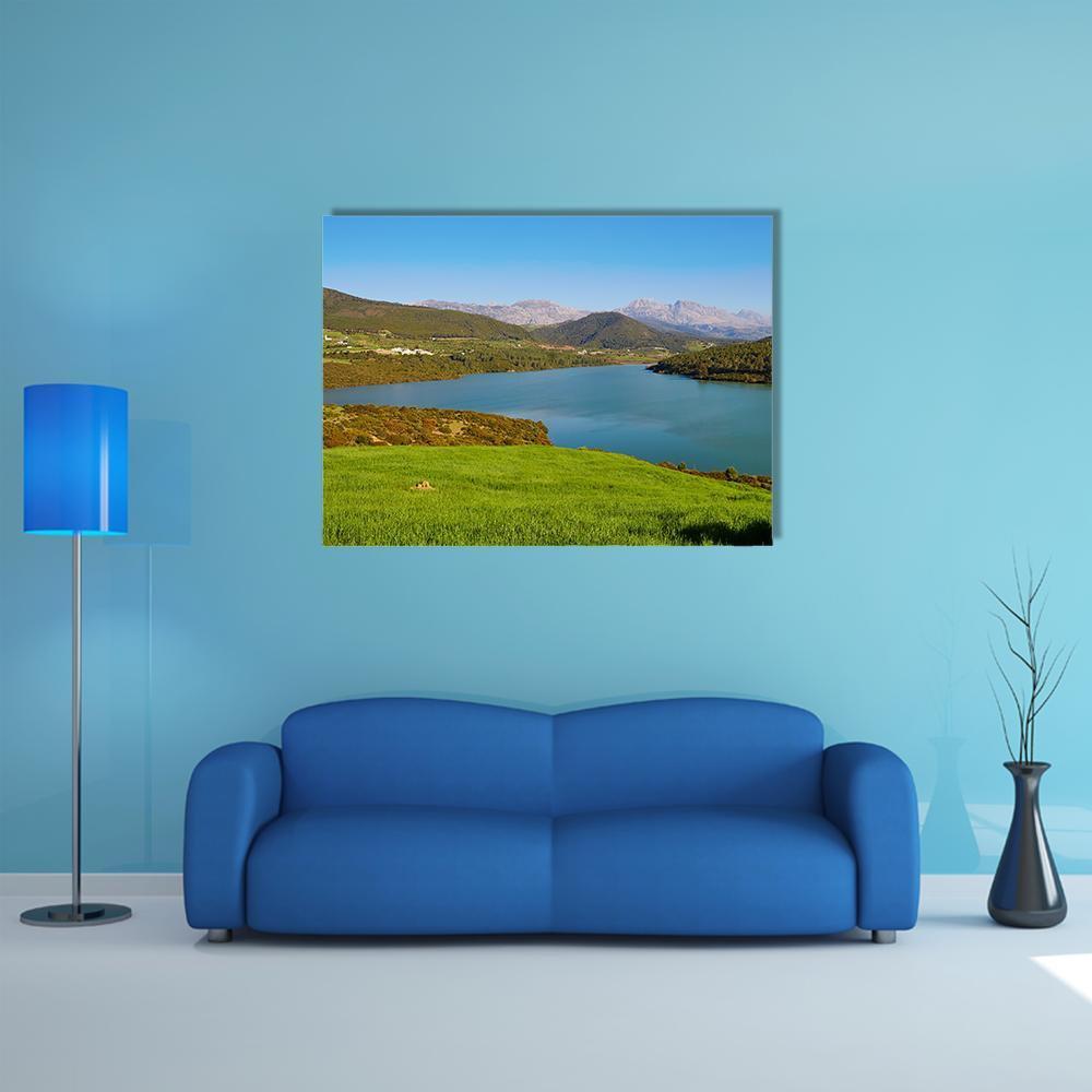 Serene Lake Among Rolling Green Hills Canvas Wall Art in green and blue, single panel hung on a wall