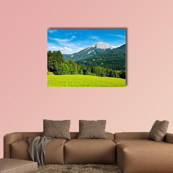 Snow-capped Mountain Over Green Meadow Canvas Wall Art in white, green and blue, single panel hung on a wall