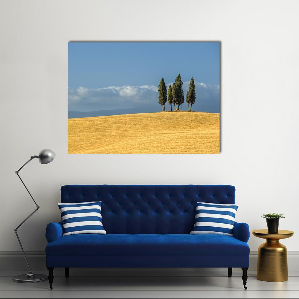 Tuscany Countryside with Cypress Trees Canvas Wall Art in yellow, green and blue, single panel hung on a wall