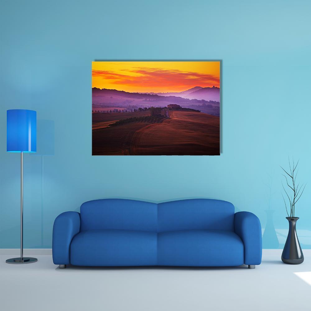 Tuscany at Sunset Canvas Wall Art in orange, yellow and purple, single panel hung on a wall