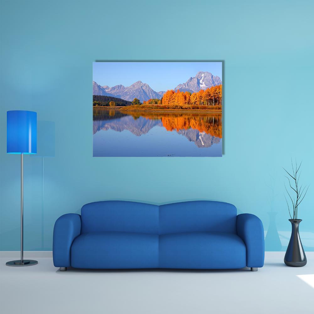 Oxbow Bend in Autumn Canvas Wall Art in orange, yellow and blue, single panel hung on a wall