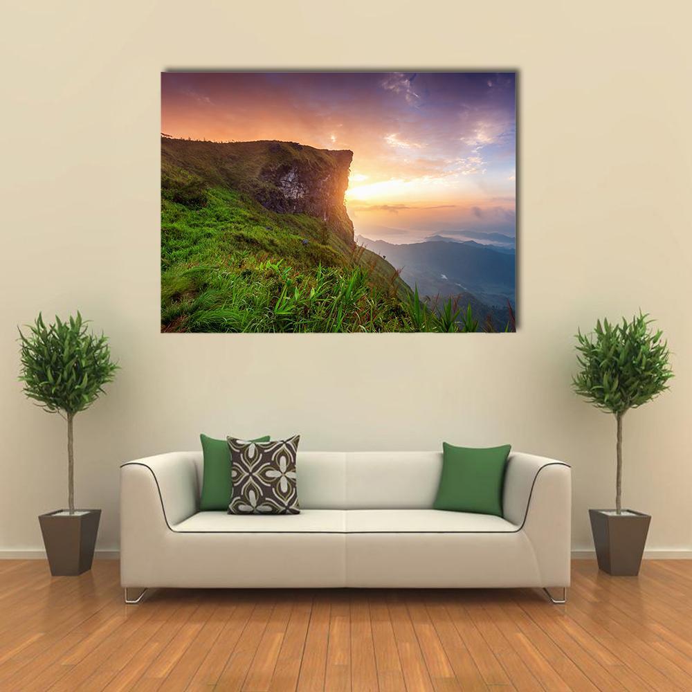 Phu Chi Fa Sunrise Cliff View Canvas Wall Art in orange, green and purple, single panel hung on a wall