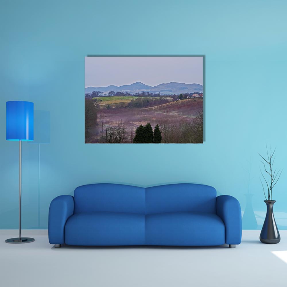 Roslin Countryside Landscape Canvas Wall Art in green, blue and purple, single panel hung on a wall