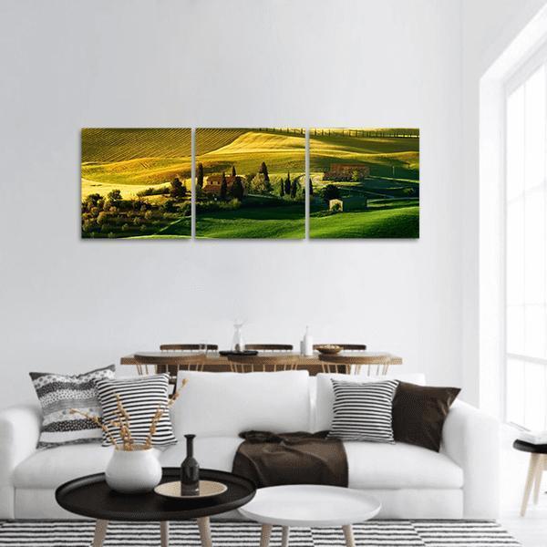 Tuscan Hills at Golden Hour Panoramic Canvas Wall Art in gold, yellow and green, hung on a wall