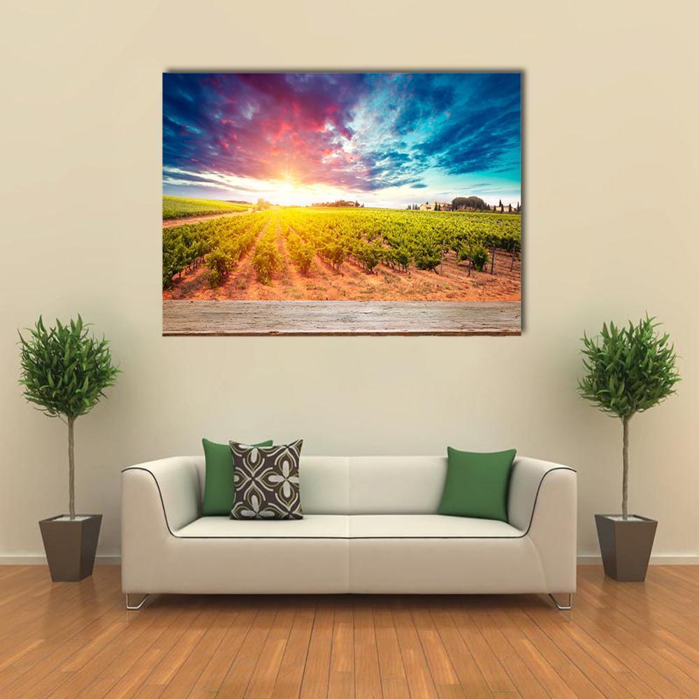 Tuscan Field at Sunset Canvas Wall Art in yellow, green and blue, single panel hung on a wall