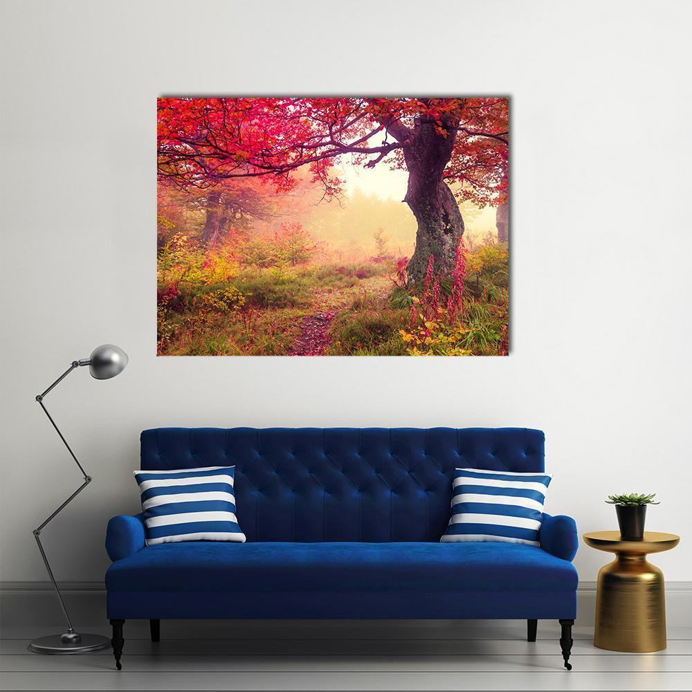 Autumn Forest Path Canvas Wall Art in red, yellow and green, single panel hung on a wall