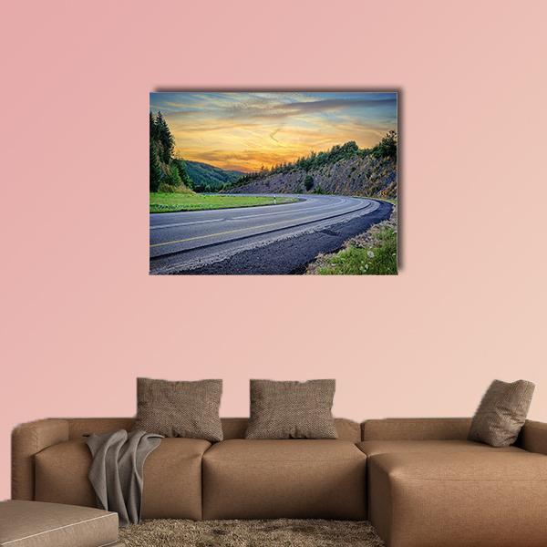Curving Mountain Road at Sunset Canvas Wall Art in orange, yellow and blue, single panel hung on a wall
