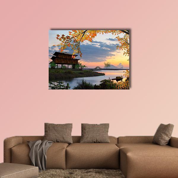 Autumn Pagoda by Lake at Sunset Canvas Wall Art in brown, orange and blue, single panel hung on a wall