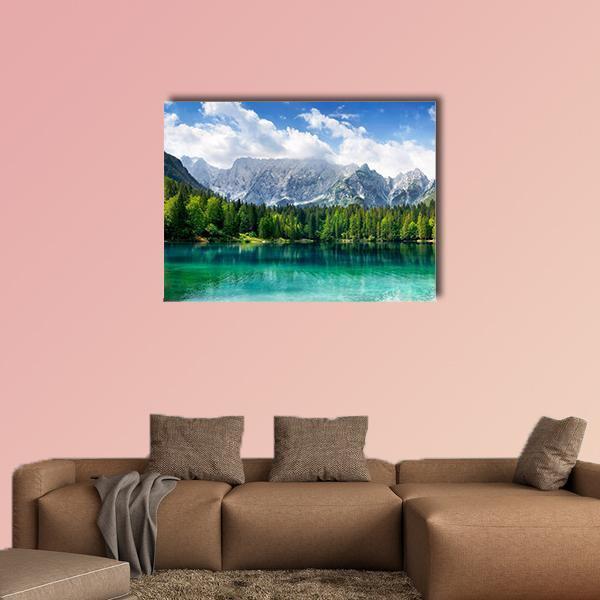 Turquoise Lake with Snow-capped Mountains Canvas Wall Art in white, green and blue, single panel hung on a wall
